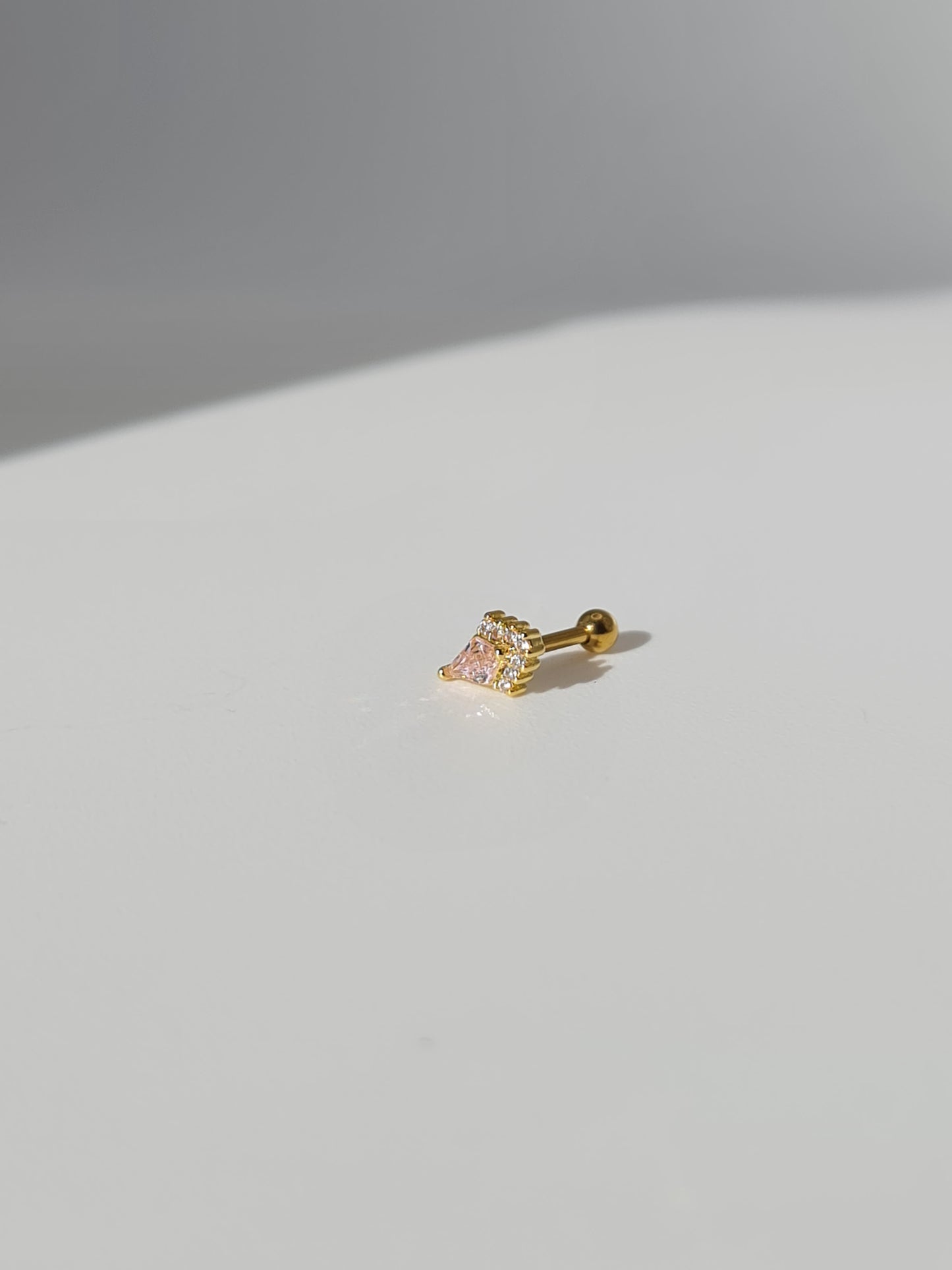 The Jordan 18k Gold Plated Titanium Steel Diamond Cut Crystal Dagger Cartilage Lobe Ball Back Stud Earring in Pink Cubic Zirconia.