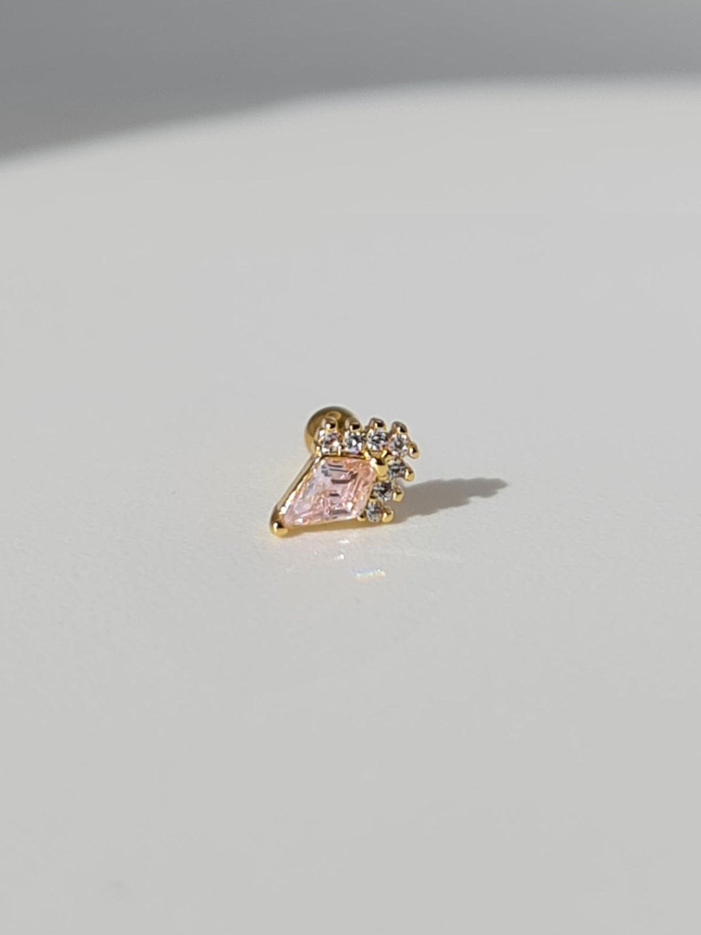 The Jordan 18k Gold Plated Titanium Steel Diamond Cut Crystal Dagger Cartilage Lobe Ball Back Stud Earring in Pink Cubic Zirconia.