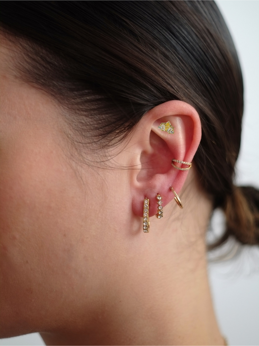 The Frankie 18k Gold Plated Titanium Steel Mixed Cluster Cut Cubic Zirconia Cartilage Lobe Single Piercing Stud Earring in Yellow.