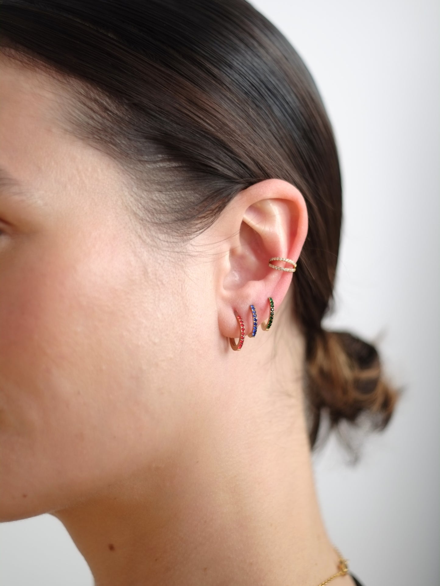 The Maija 'April' Diamond CZ Birthstone 18k Gold Plated Stainless Steel Crystal Huggie Hoop Earrings.