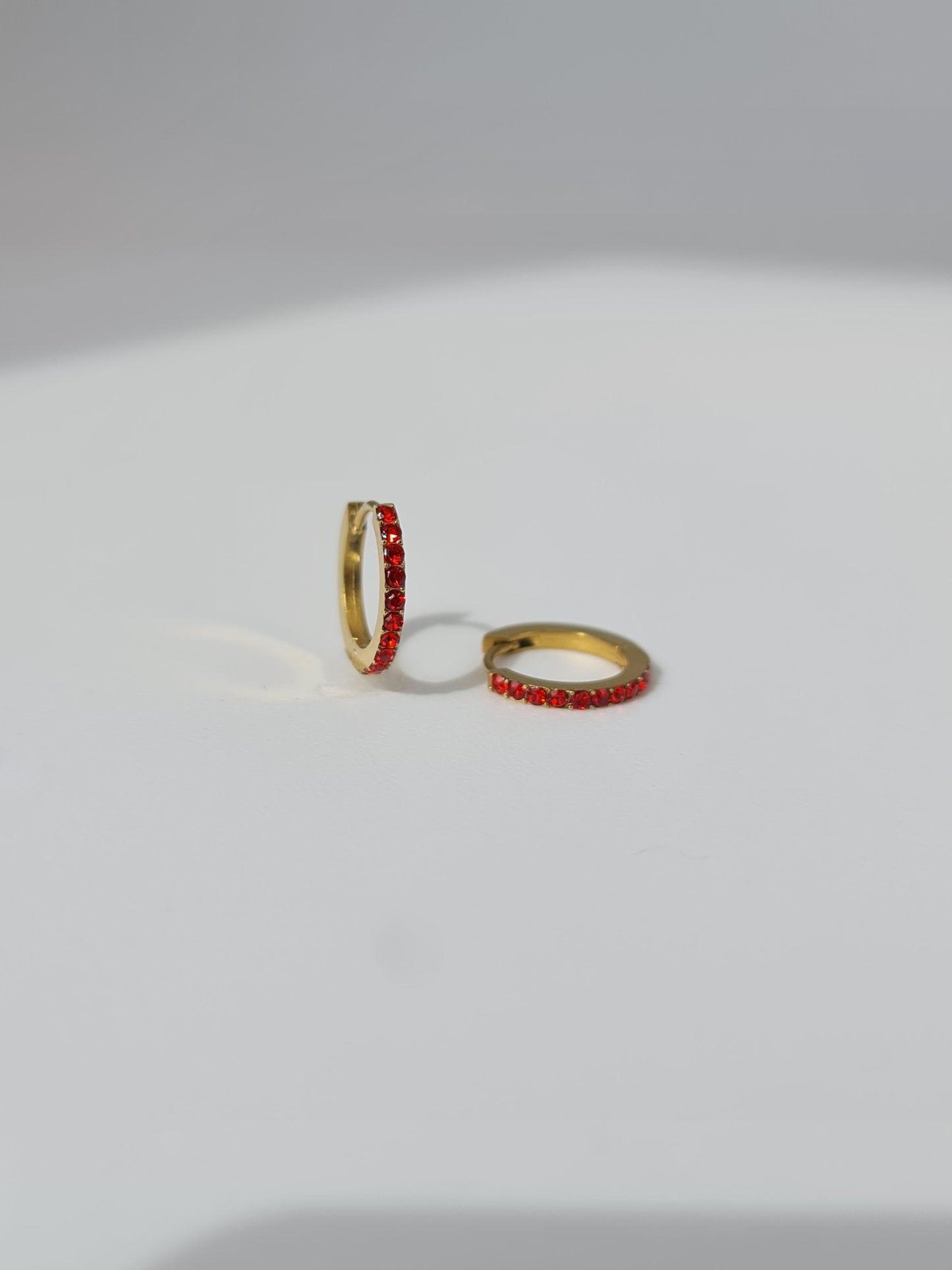 The Maija 'January' Garnet Birthstone 18k Gold Plated Stainless Steel Crystal Huggie Hoop Earrings.