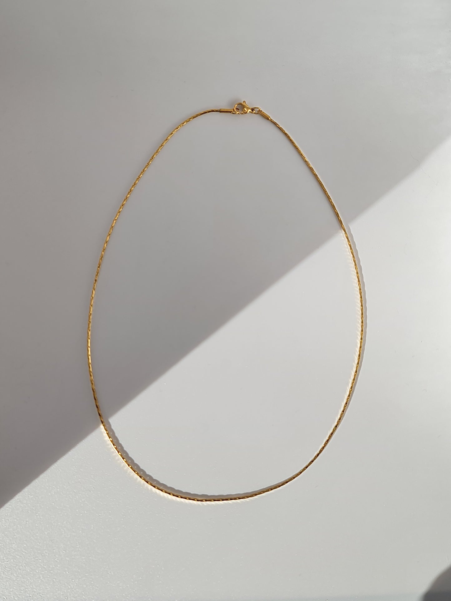 The Arizona 18k Gold Plated Stainless Steel Delicate Round Cobra Snake Chain Necklace.