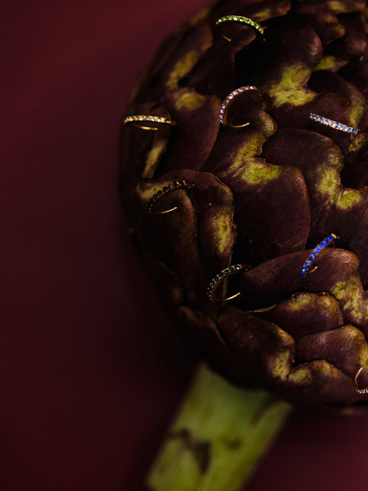The Maija 'May' Emerald Birthstone 18k Gold Plated Stainless Steel Crystal Huggie Hoop Earrings.