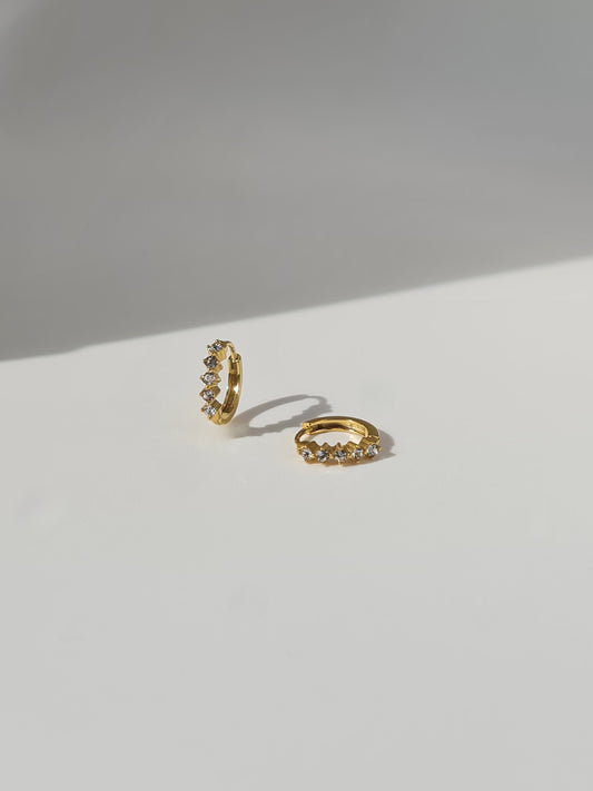 The Cameron 18k Gold Plated Stainless Steel Cubic Zirconia Crystal Huggie Hoop Earrings.