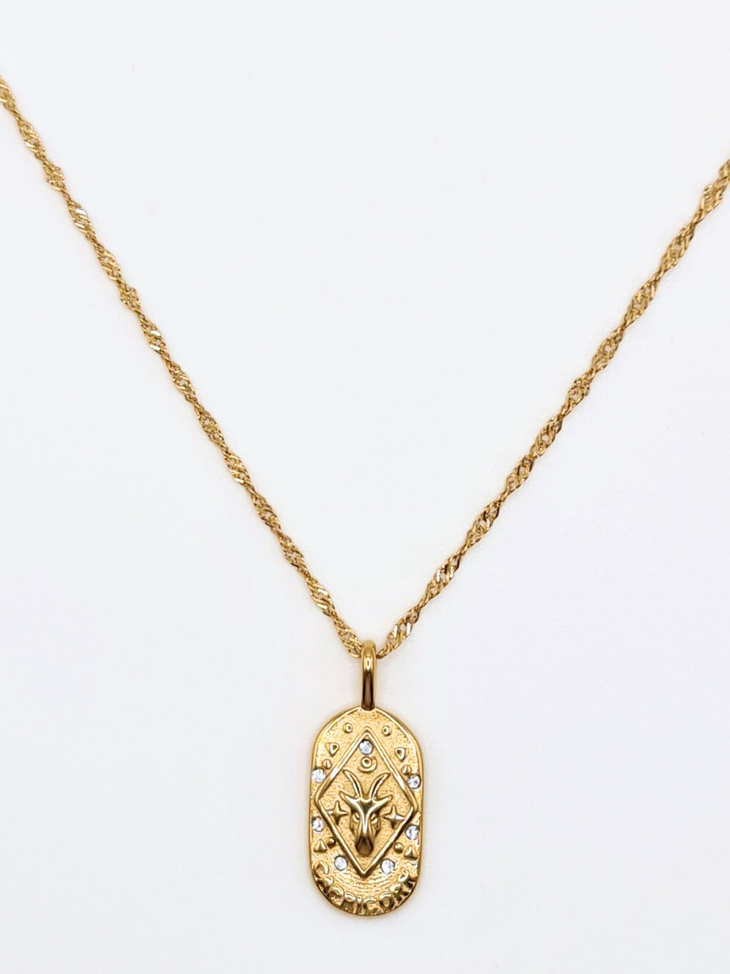 The Kiki Capricorn 18k Gold Plated Stainless Steel Zodiac Starsign Crystal Necklace.