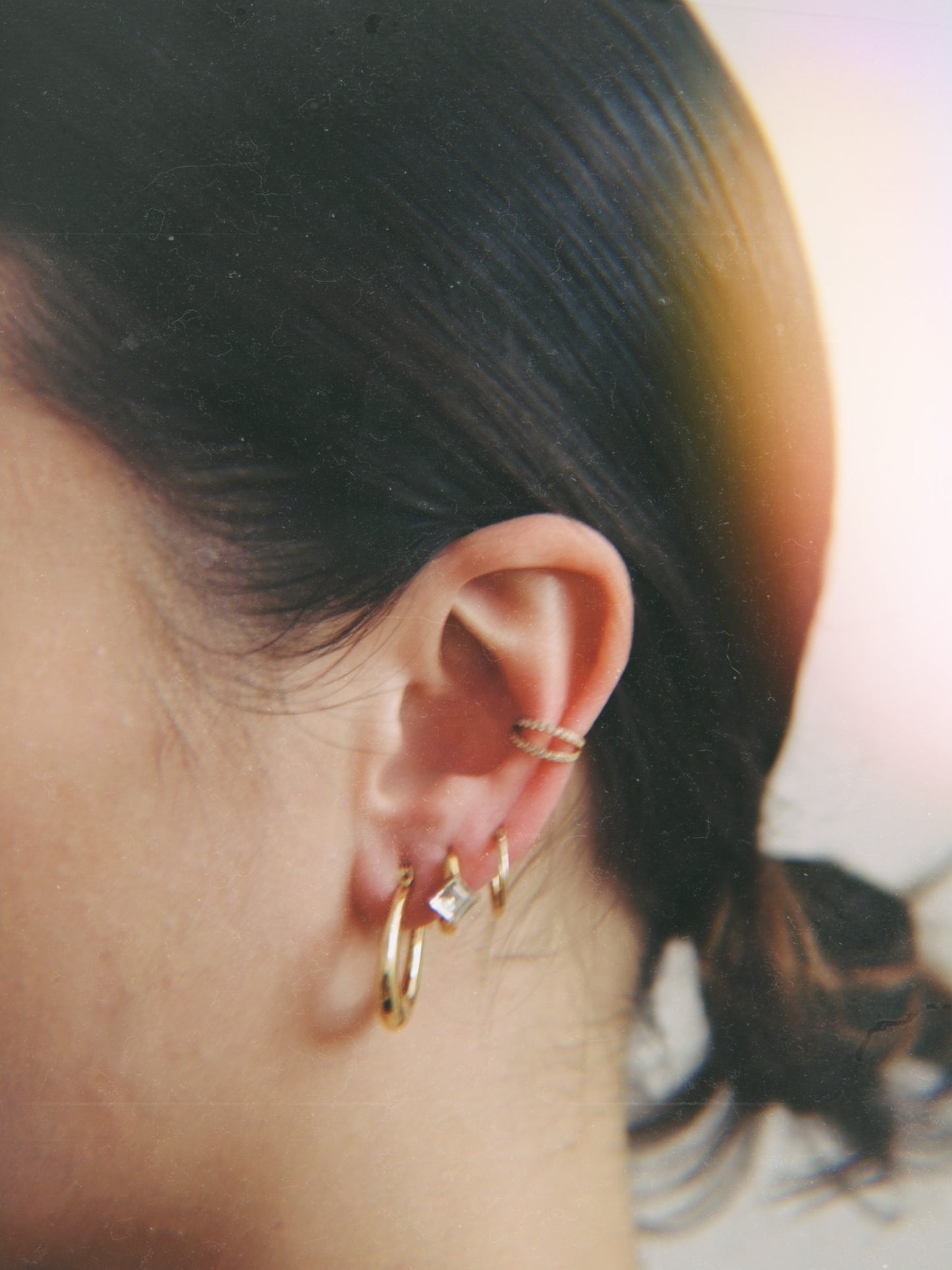 The Billie 18k Gold Plated Stainless Steel Princess Cut Cubic Zirconia Crystal Huggie Hoop Earrings.