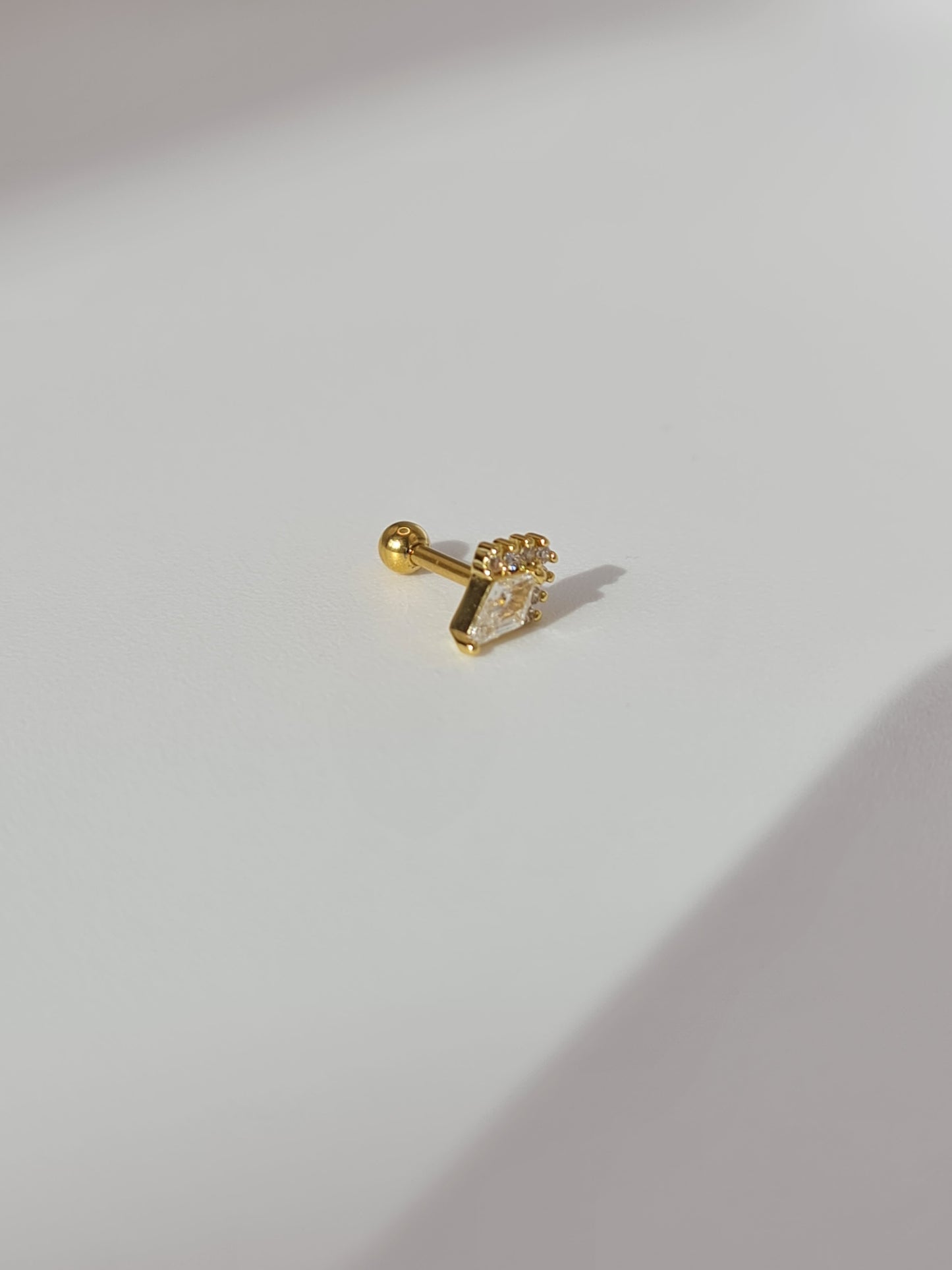 The Jordan 18k Gold Plated Titanium Steel Diamond Cut Dagger Cartilage Lobe Ball Back Stud Earring in Crystal Cubic Zirconia.