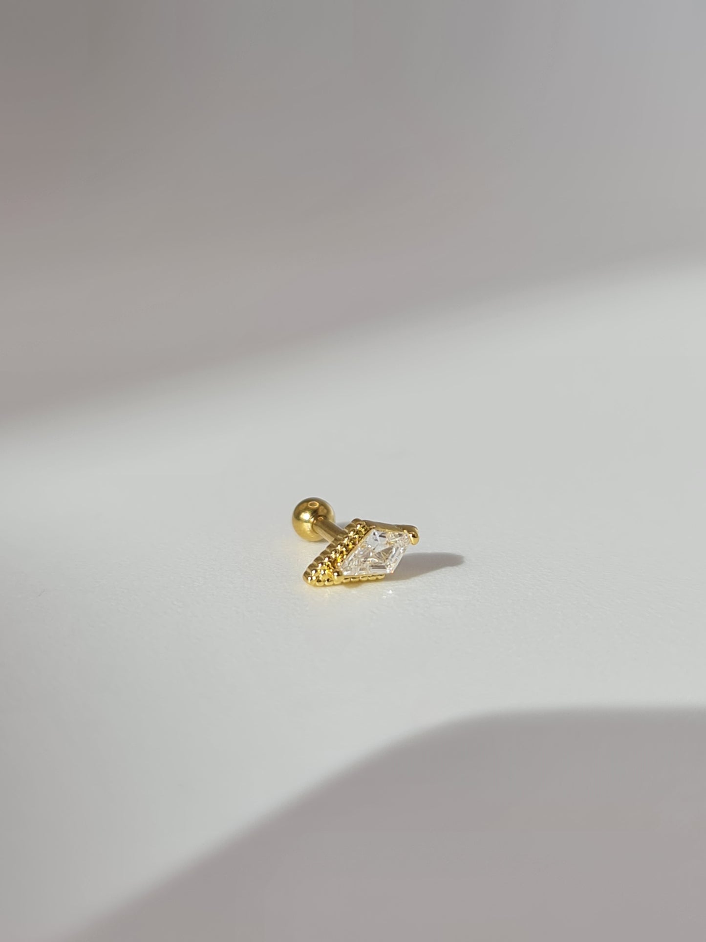 The Jordan 18k Gold Plated Titanium Steel Cubic Zirconia Diamond Cut Dagger Cartilage Lobe Single Piercing Stud Earring.