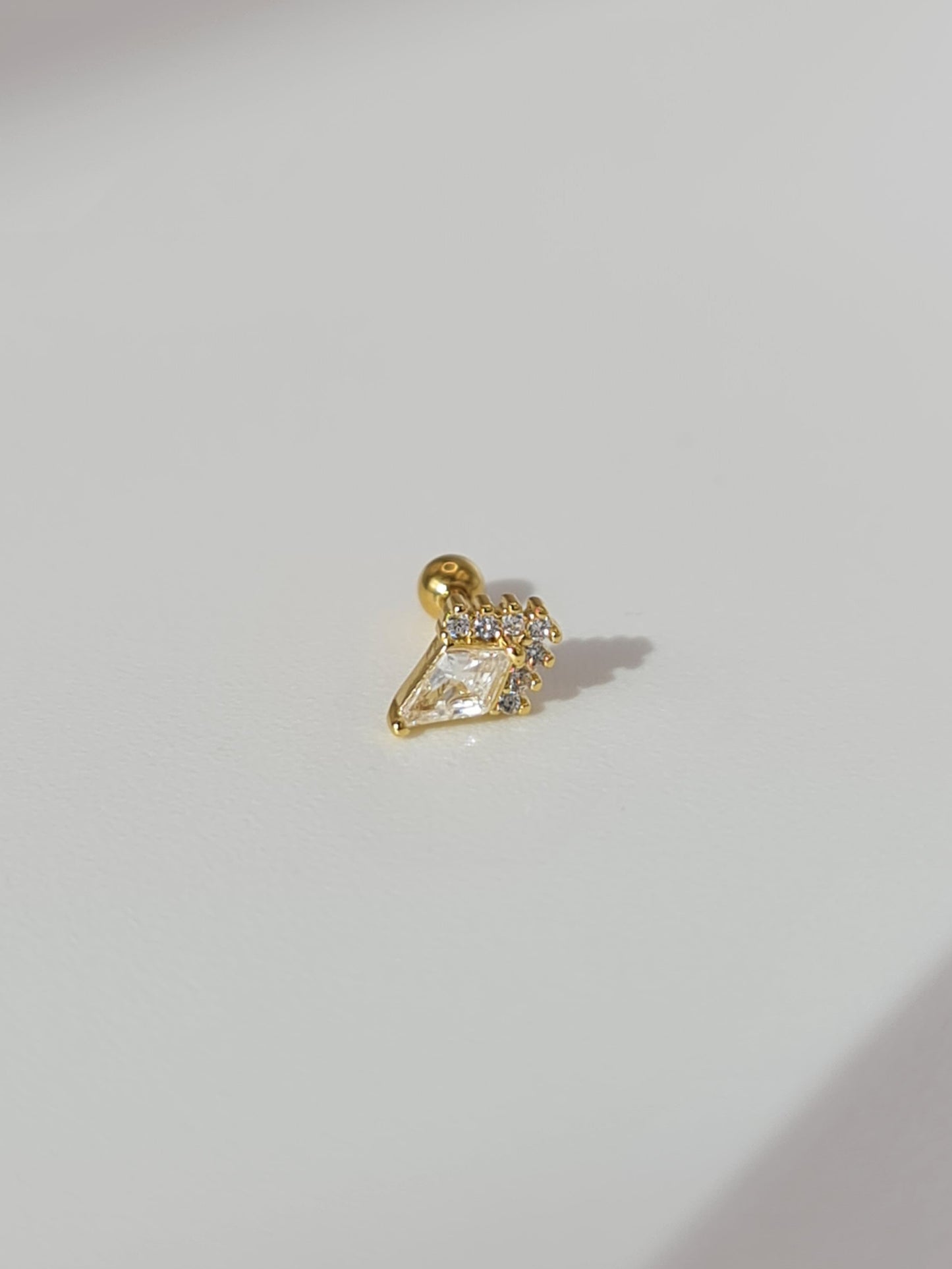 The Jordan 18k Gold Plated Titanium Steel Diamond Cut Dagger Cartilage Lobe Ball Back Stud Earring in Crystal Cubic Zirconia.
