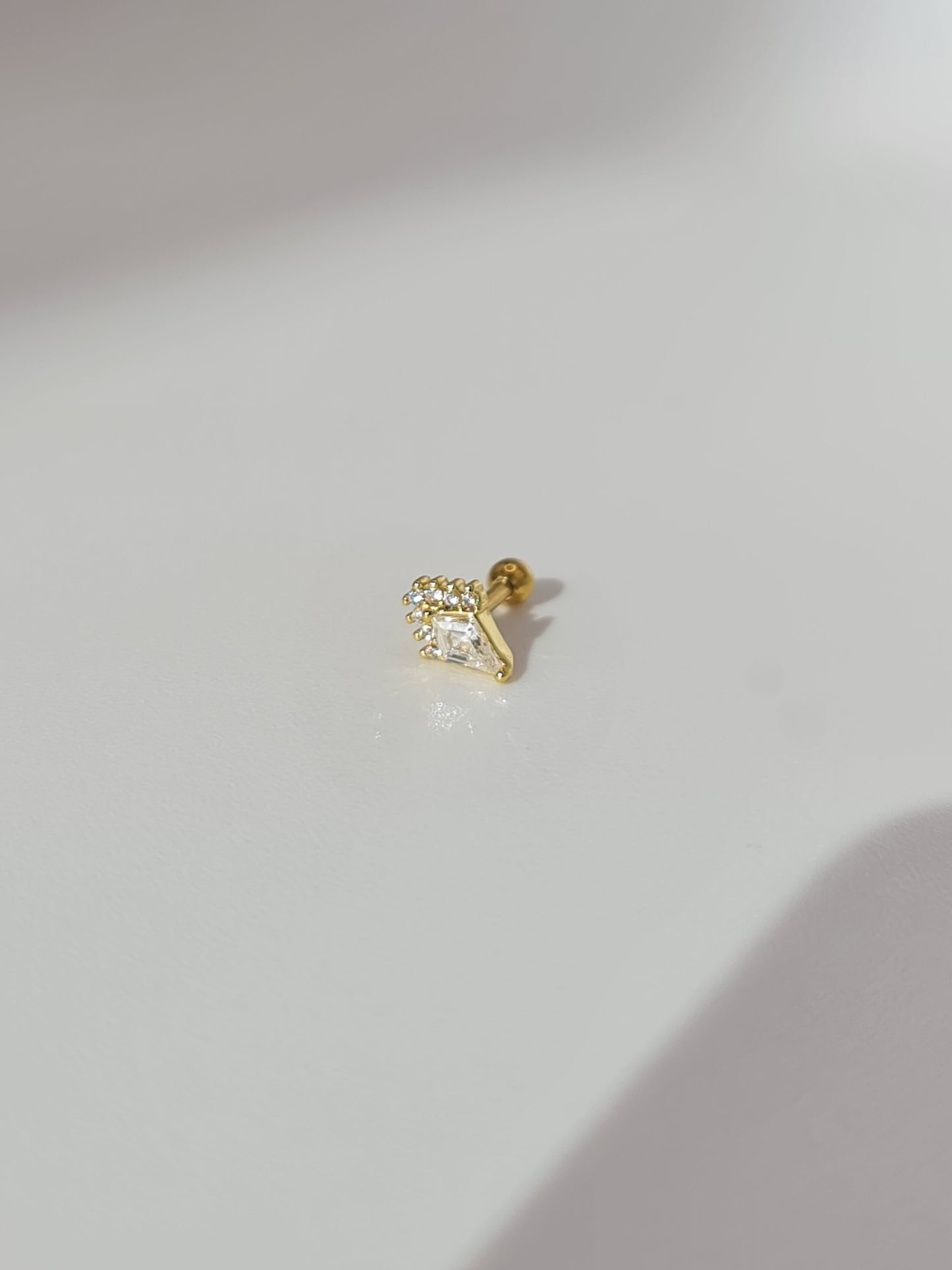 The Jordan 18k Gold Plated Titanium Steel Diamond Cut Dagger Cartilage Lobe Ball Back Stud Earring in Crystal Cubic Zirconia.