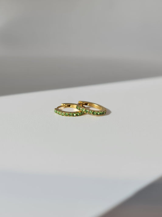 The Maija 'August' Peridot Birthstone 18k Gold Plated Stainless Steel Crystal Huggie Hoop Earrings.