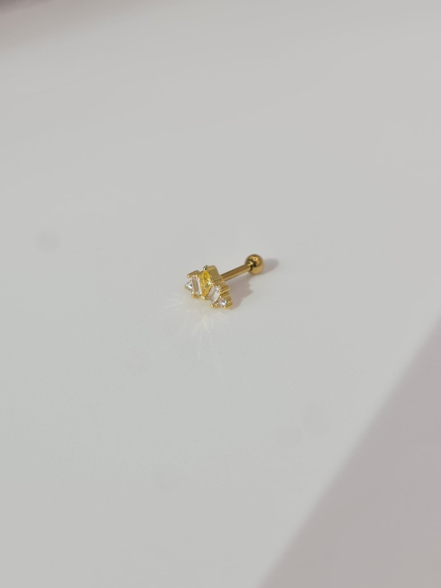 The Frankie 18k Gold Plated Titanium Steel Mixed Cluster Cut Cubic Zirconia Cartilage Lobe Stud Earring in Yellow.