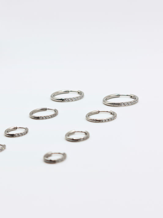 The Alaia Essentials Silver Finish Tarnish-Free Crystal Pave Huggie Hoop Earrings in 16mm