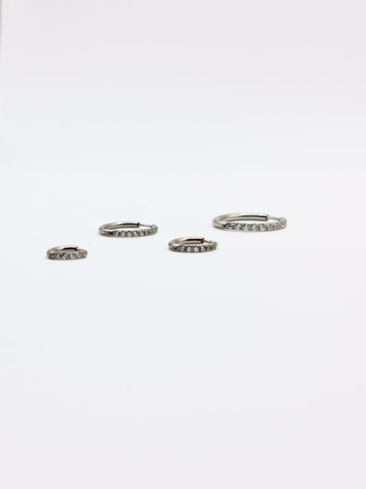 The Alaia Essentials Silver Finish Tarnish-Free Crystal Pave Huggie Hoop Earrings in 8mm