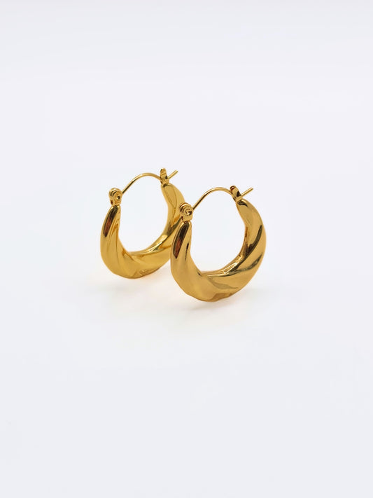The Anastasia 18k Gold Plated Stainless Steel Medium Twist Hoop Earrings.