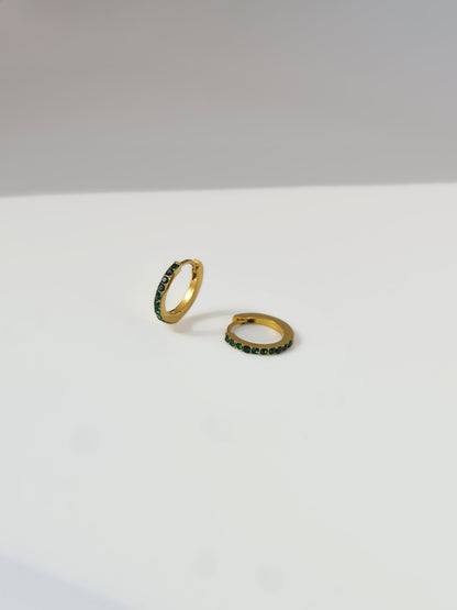 The Maija 'May' Emerald Birthstone 18k Gold Plated Stainless Steel Crystal Huggie Hoop Earrings.