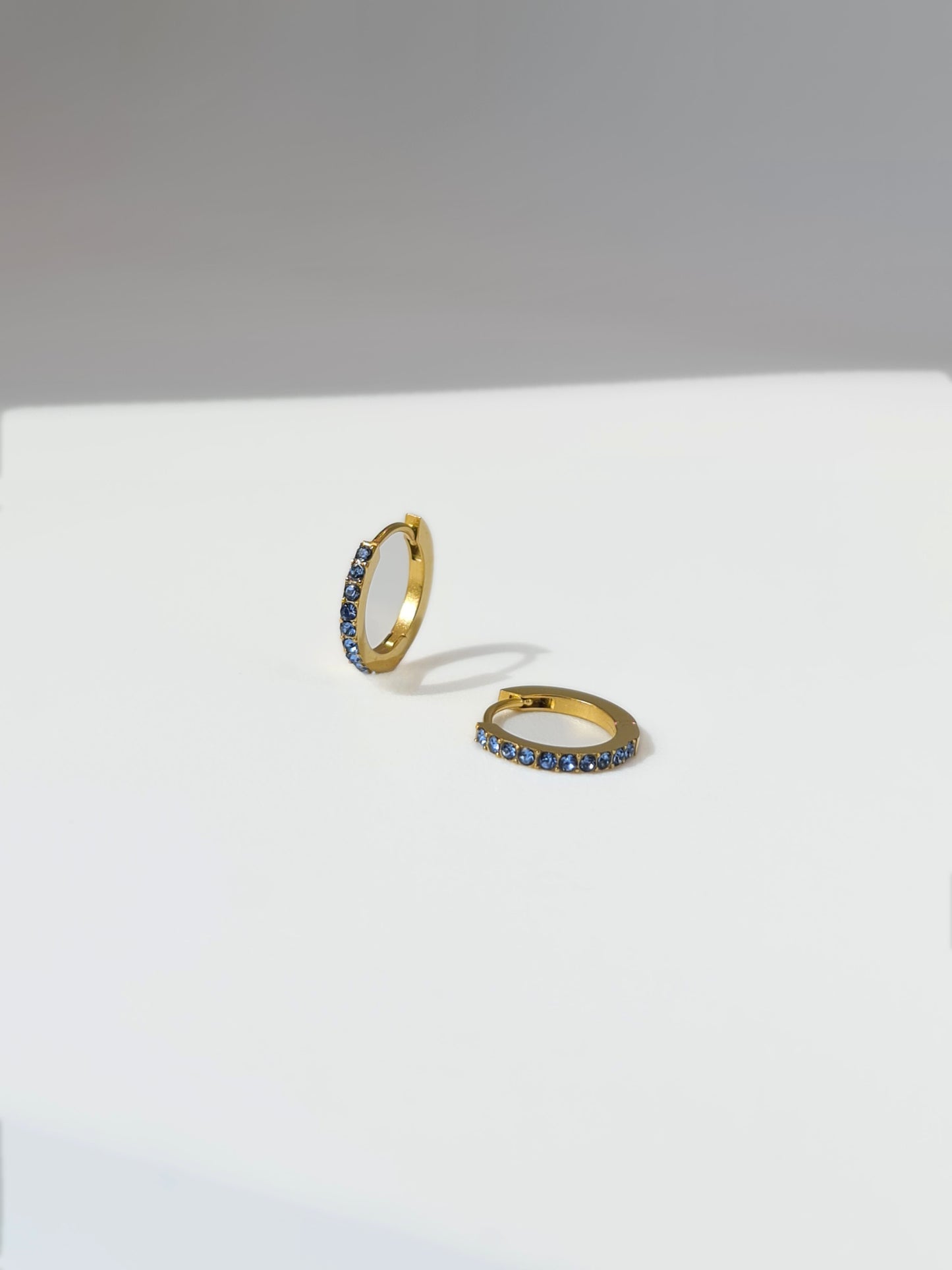 The Maija 'March' Aquamarine Birthstone 18k Gold Plated Stainless Steel Crystal Huggie Hoop Earrings.