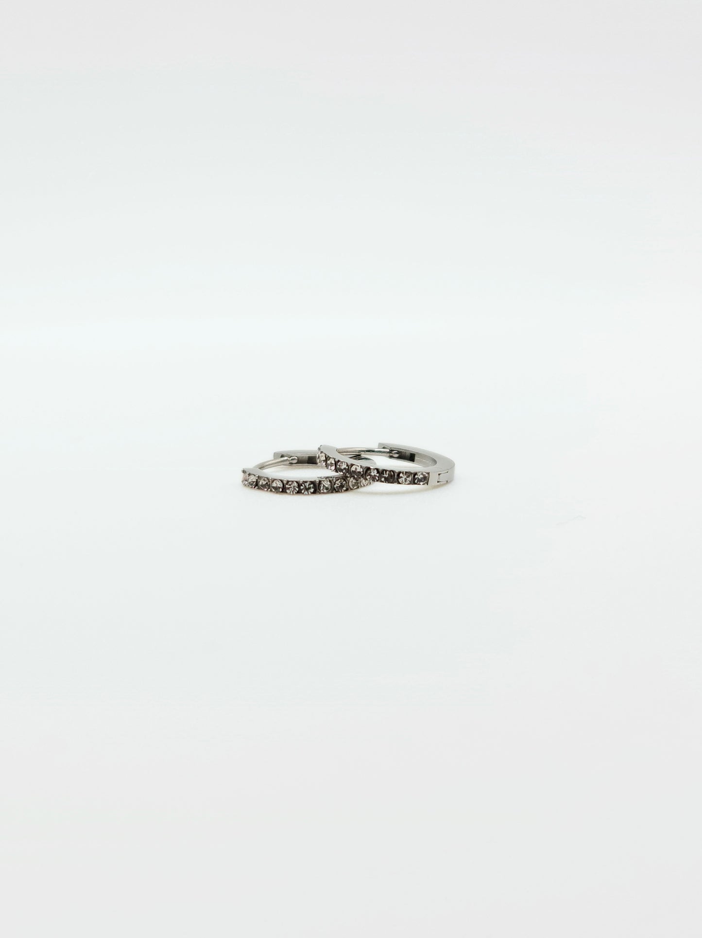 The Maija 'April' Diamond CZ Birthstone Silver Finish Tarnish Free Crystal Huggie Hoop Earrings.