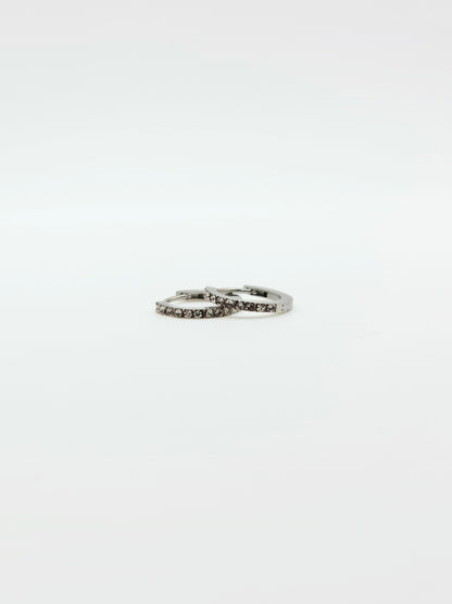 The Maija 'April' Diamond CZ Birthstone Silver Finish Tarnish Free Crystal Huggie Hoop Earrings.