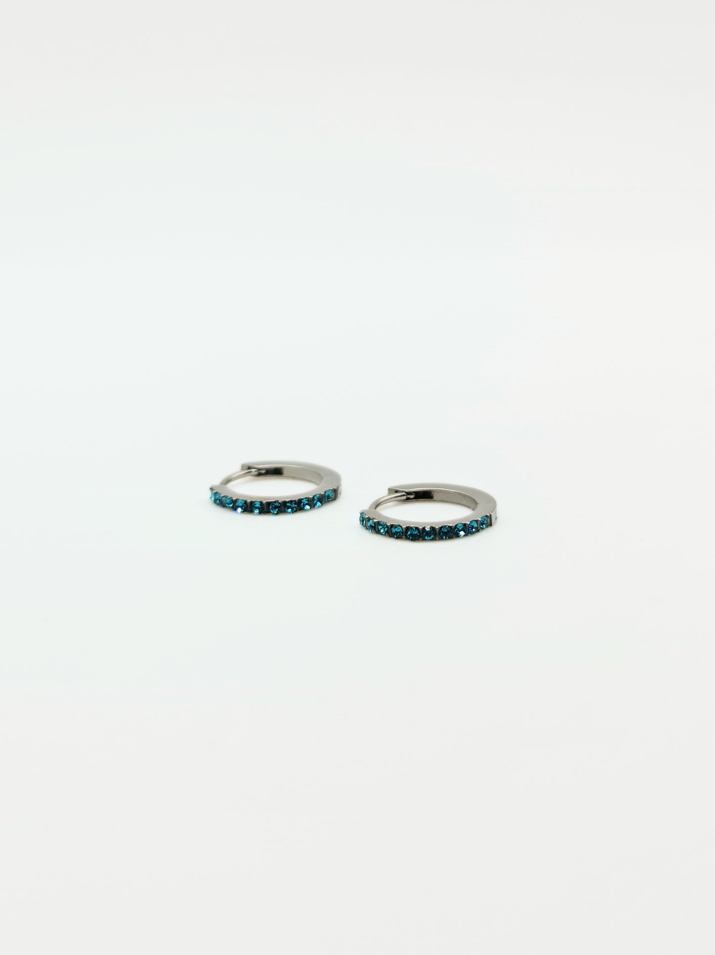 The Maija 'December' Turquoise Birthstone Silver Finish Tarnish Free Crystal Huggie Hoop Earrings.
