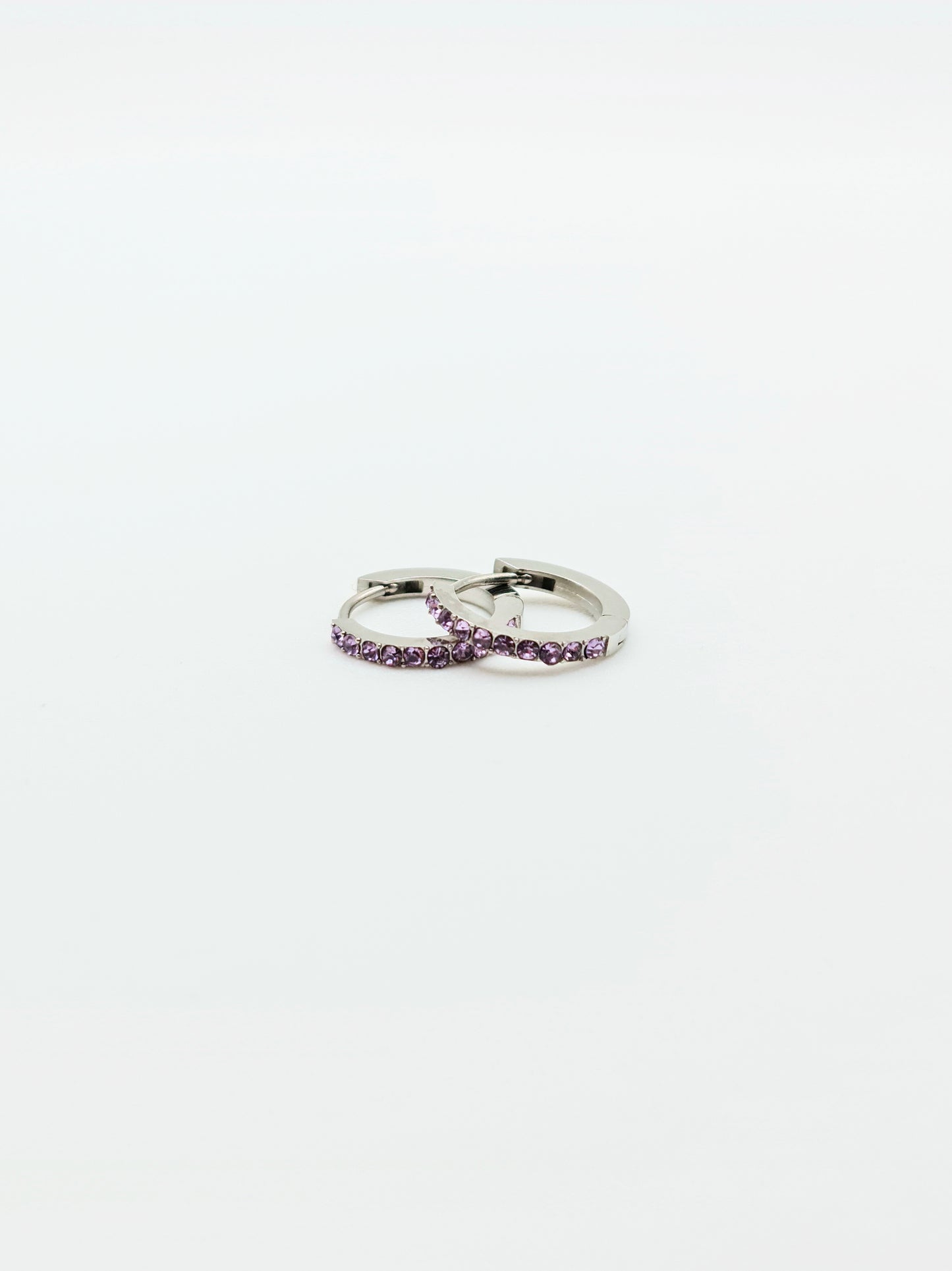 The Maija 'February' Amethyst Birthstone Silver Finish Tarnish Free Crystal Huggie Hoop Earrings.