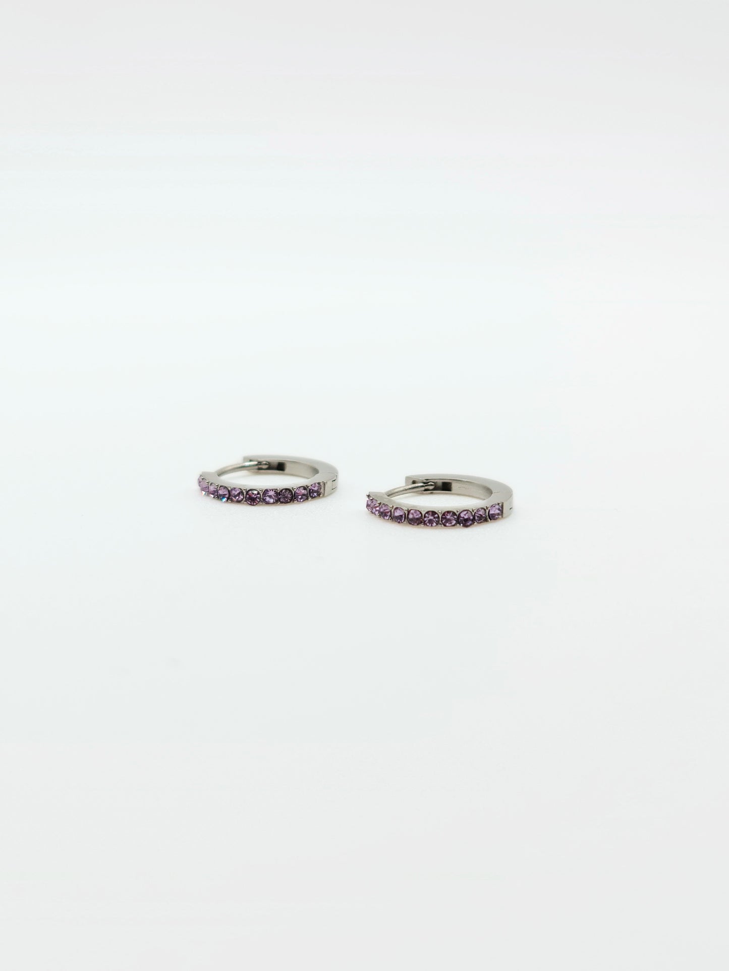 The Maija 'February' Amethyst Birthstone Silver Finish Tarnish Free Crystal Huggie Hoop Earrings.