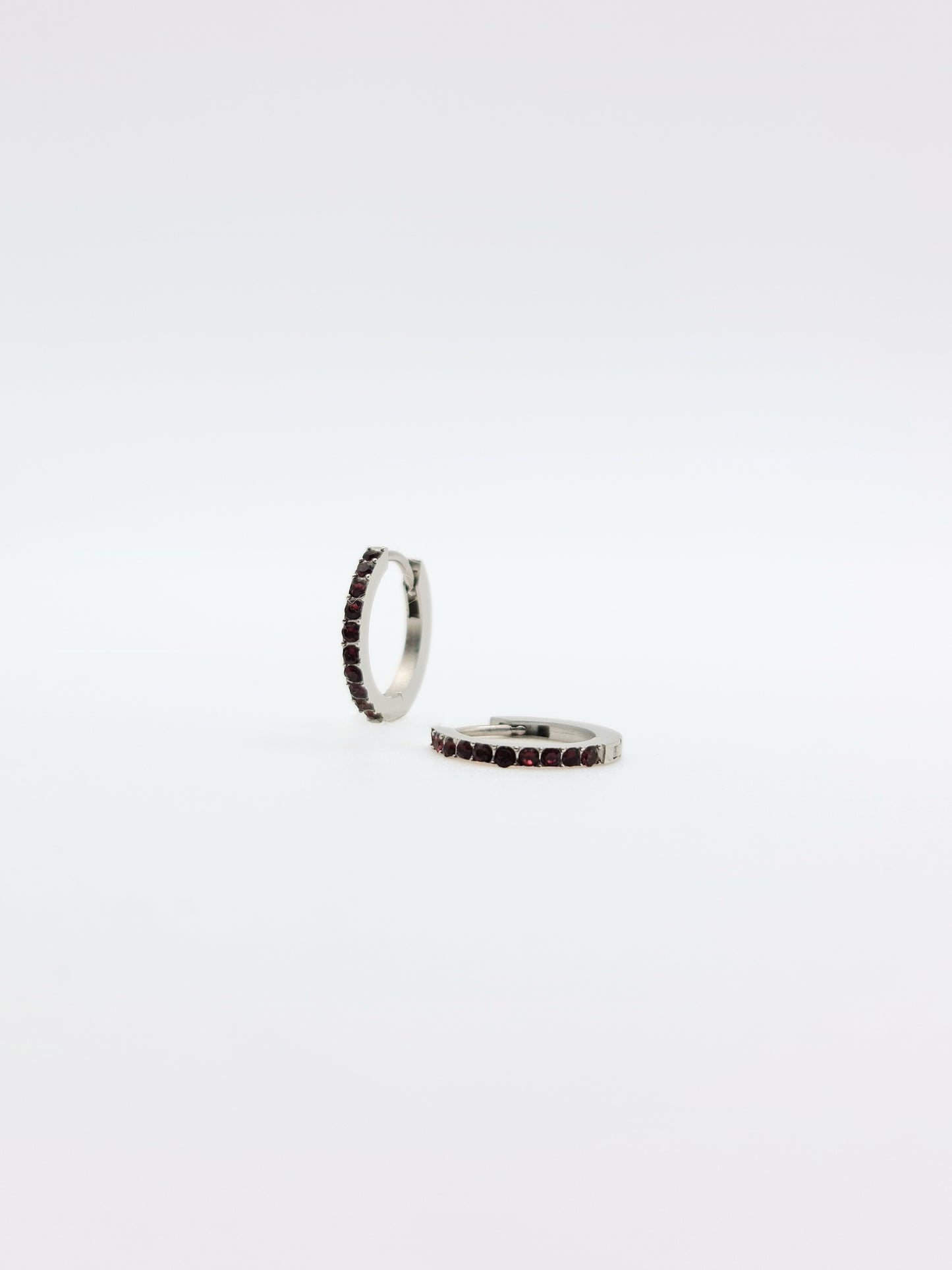 The Maija 'July' Ruby Birthstone Silver Finish Tarnish Free Crystal Huggie Hoop Earrings.