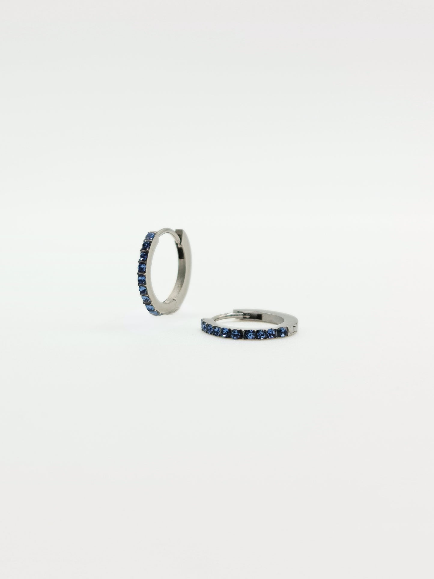 The Maija 'March' Aquamarine Birthstone Silver Finish Tarnish Free Crystal Huggie Hoop Earrings.