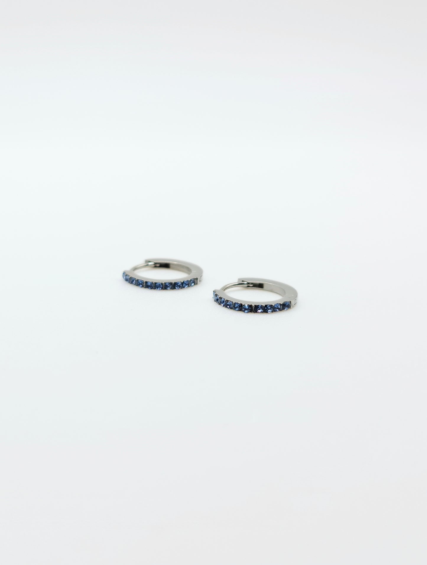 The Maija 'March' Aquamarine Birthstone Silver Finish Tarnish Free Crystal Huggie Hoop Earrings.