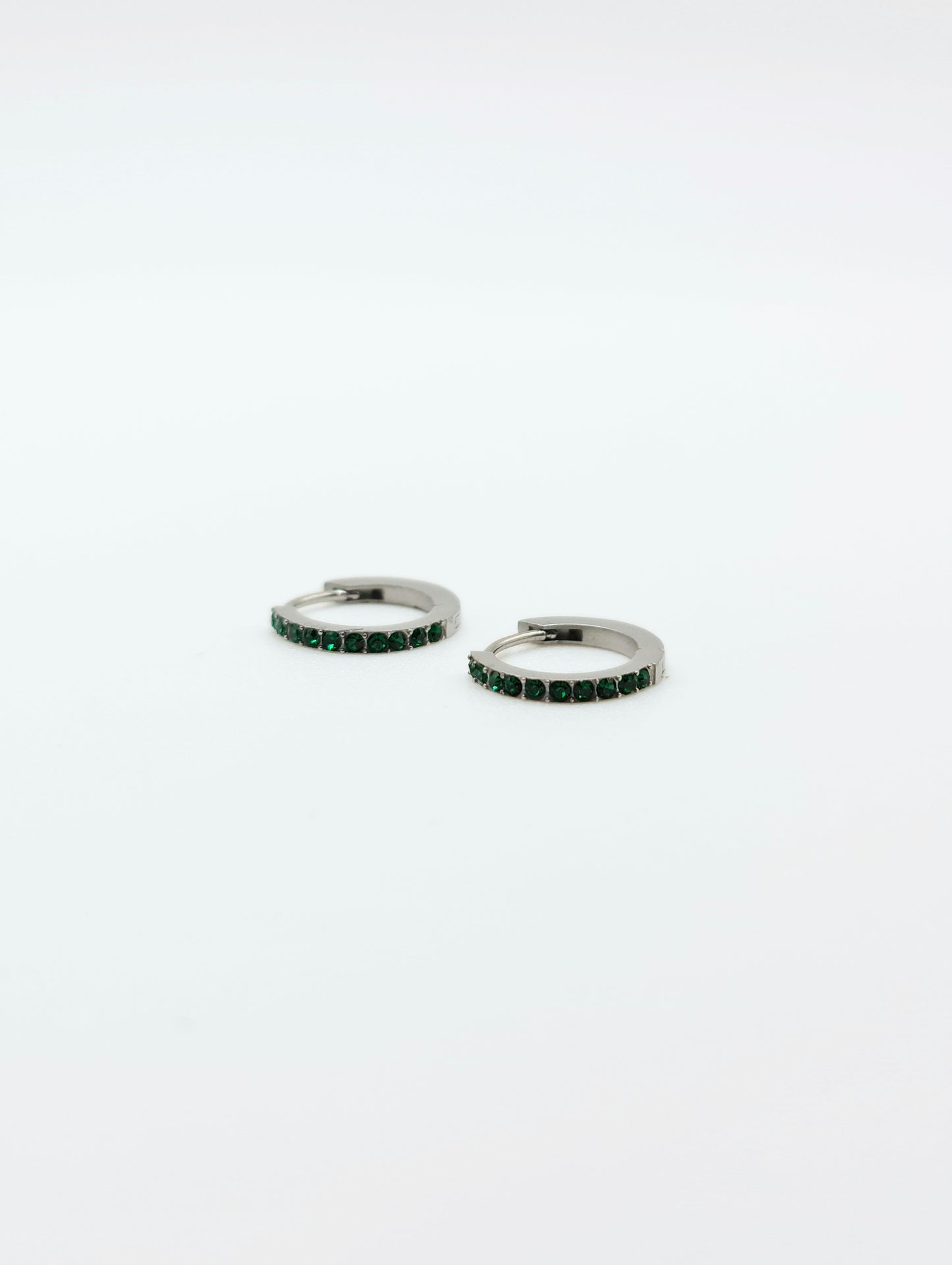 The Maija 'May' Emerald Birthstone Silver Finish Tarnish Free Crystal Huggie Hoop Earrings.
