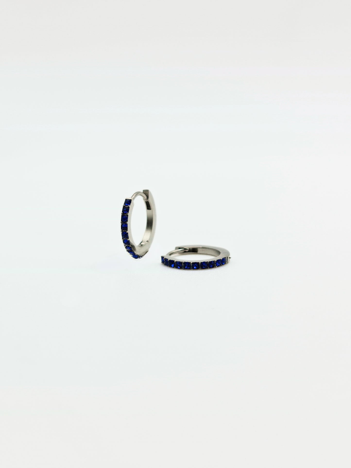 The Maija 'September' Sapphire Birthstone Silver Finish Tarnish Free Crystal Huggie Hoop Earrings.