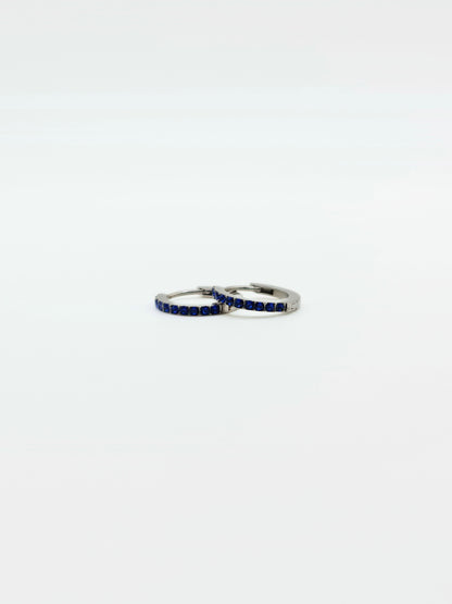 The Maija 'September' Sapphire Birthstone Silver Finish Tarnish Free Crystal Huggie Hoop Earrings.