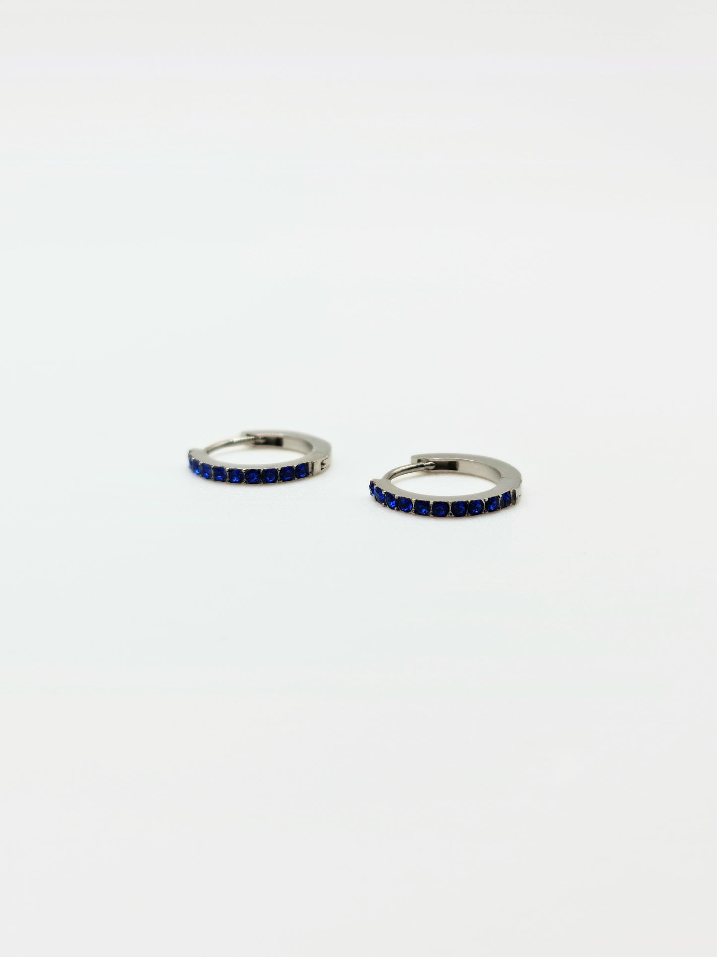 The Maija 'September' Sapphire Birthstone Silver Finish Tarnish Free Crystal Huggie Hoop Earrings.