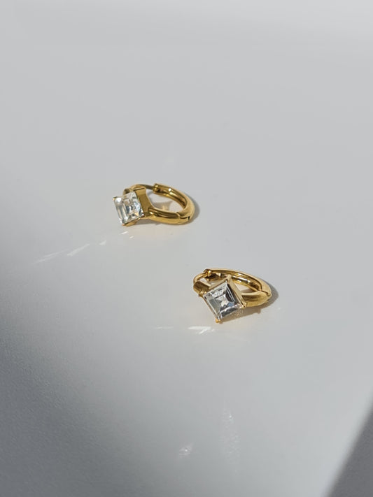 The Billie 18k Gold Plated Stainless Steel Princess Cut Cubic Zirconia Crystal Huggie Hoop Earrings.