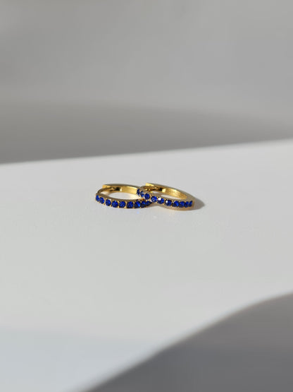 The Maija 'September' Sapphire Birthstone 18k Gold Plated Stainless Steel Crystal Huggie Hoop Earrings.