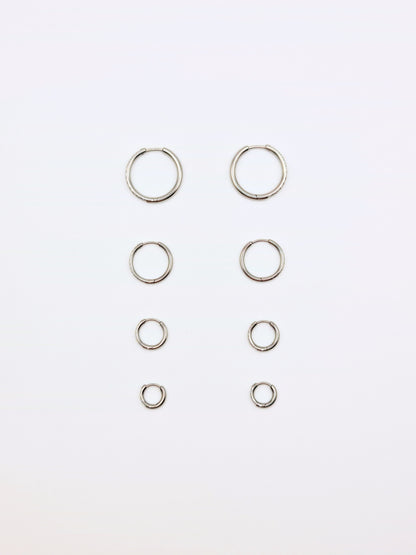 The Alaia Essentials Silver Finish Tarnish-Free Crystal Pave Huggie Hoop Earrings in 8mm