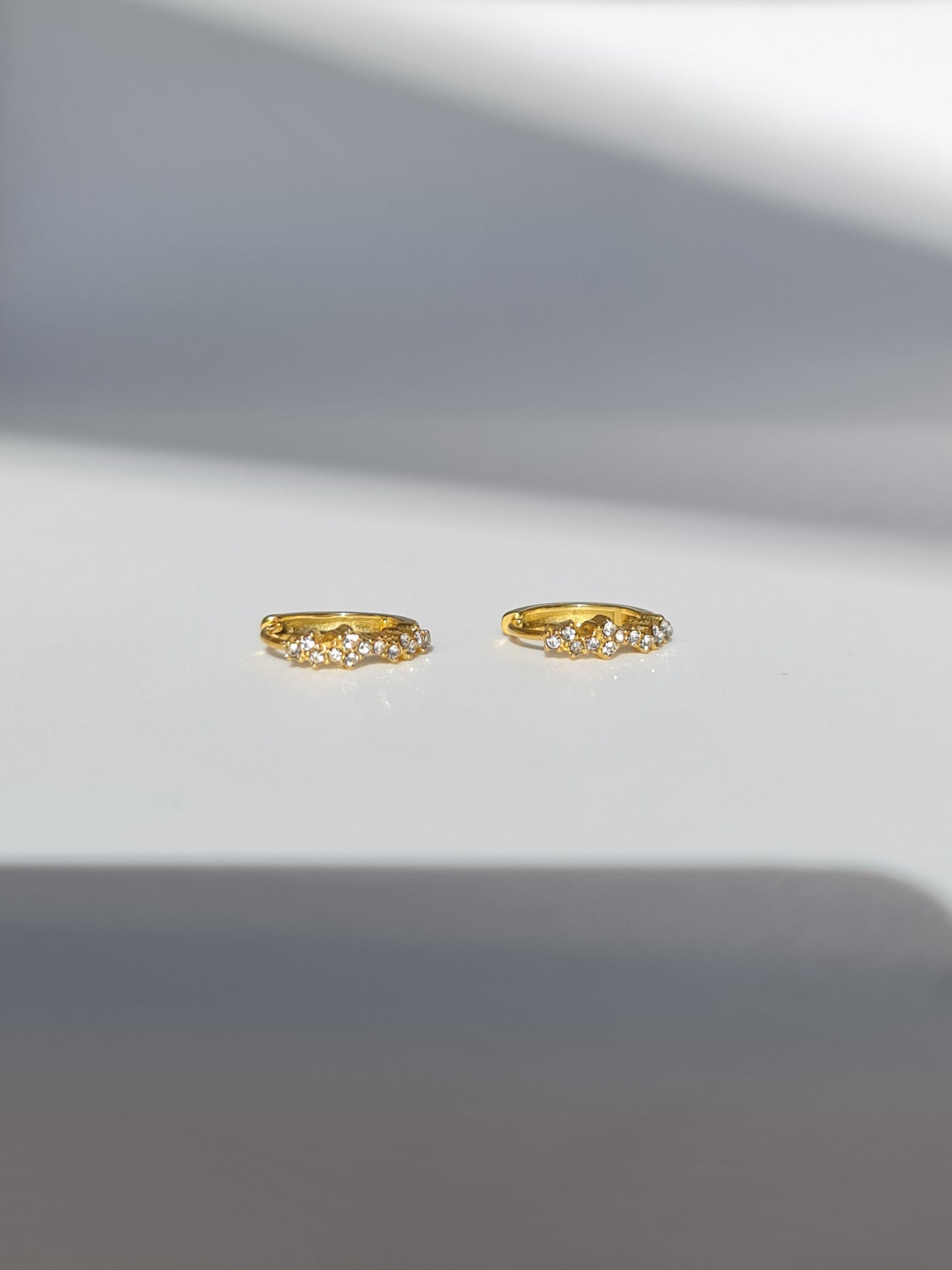 The Aurora 18k Gold Plated Stainless Steel Cubic Zirconia Pave Crystal Celestial Constellation Huggie Hoop Earrings.