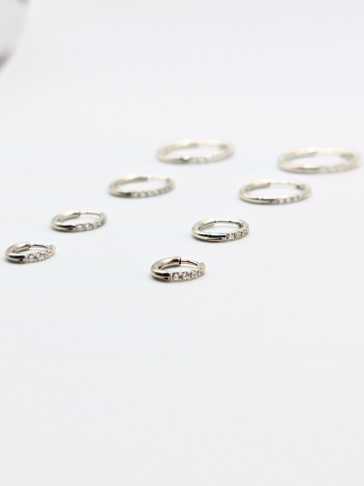 The Alaia Essentials Silver Finish Tarnish-Free Crystal Pave Huggie Hoop Earrings in 6mm