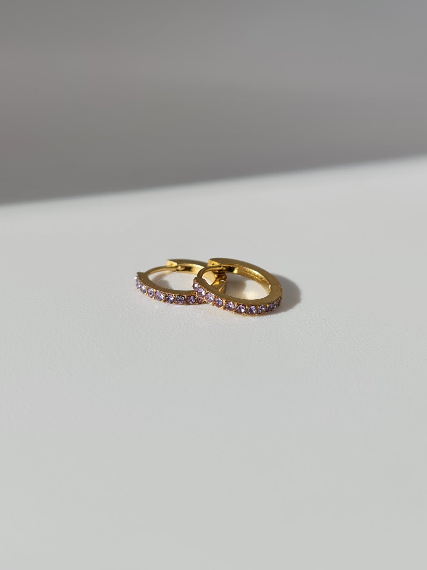 The Maija 'February' Amethyst Birthstone 18k Gold Plated Stainless Steel Crystal Huggie Hoop Earrings.