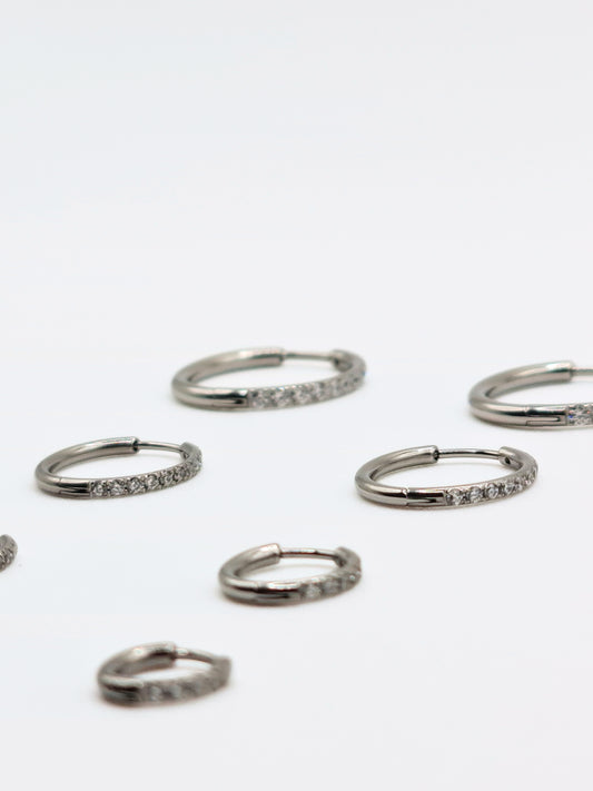 The Alaia Essentials Silver Finish Tarnish-Free Crystal Pave Huggie Hoop Earrings in 12mm