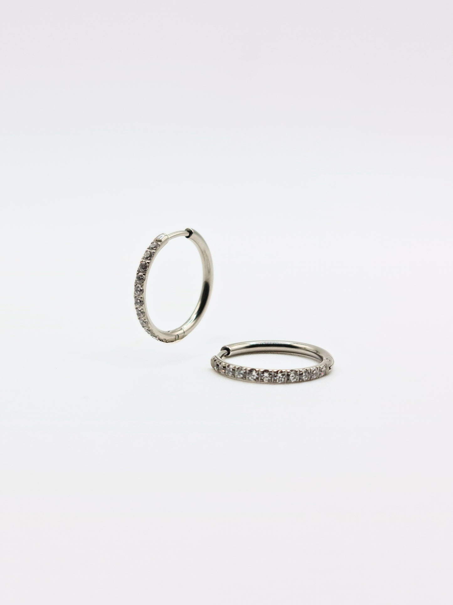 The Alaia Essentials Silver Finish Tarnish-Free Crystal Pave Huggie Hoop Earrings in 16mm