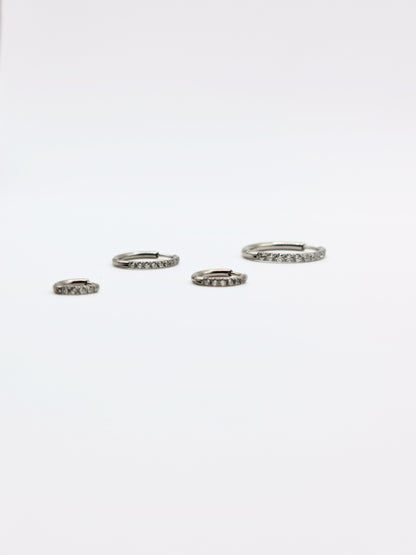 The Alaia Essentials Silver Finish Tarnish-Free Crystal Pave Huggie Hoop Earrings in 16mm