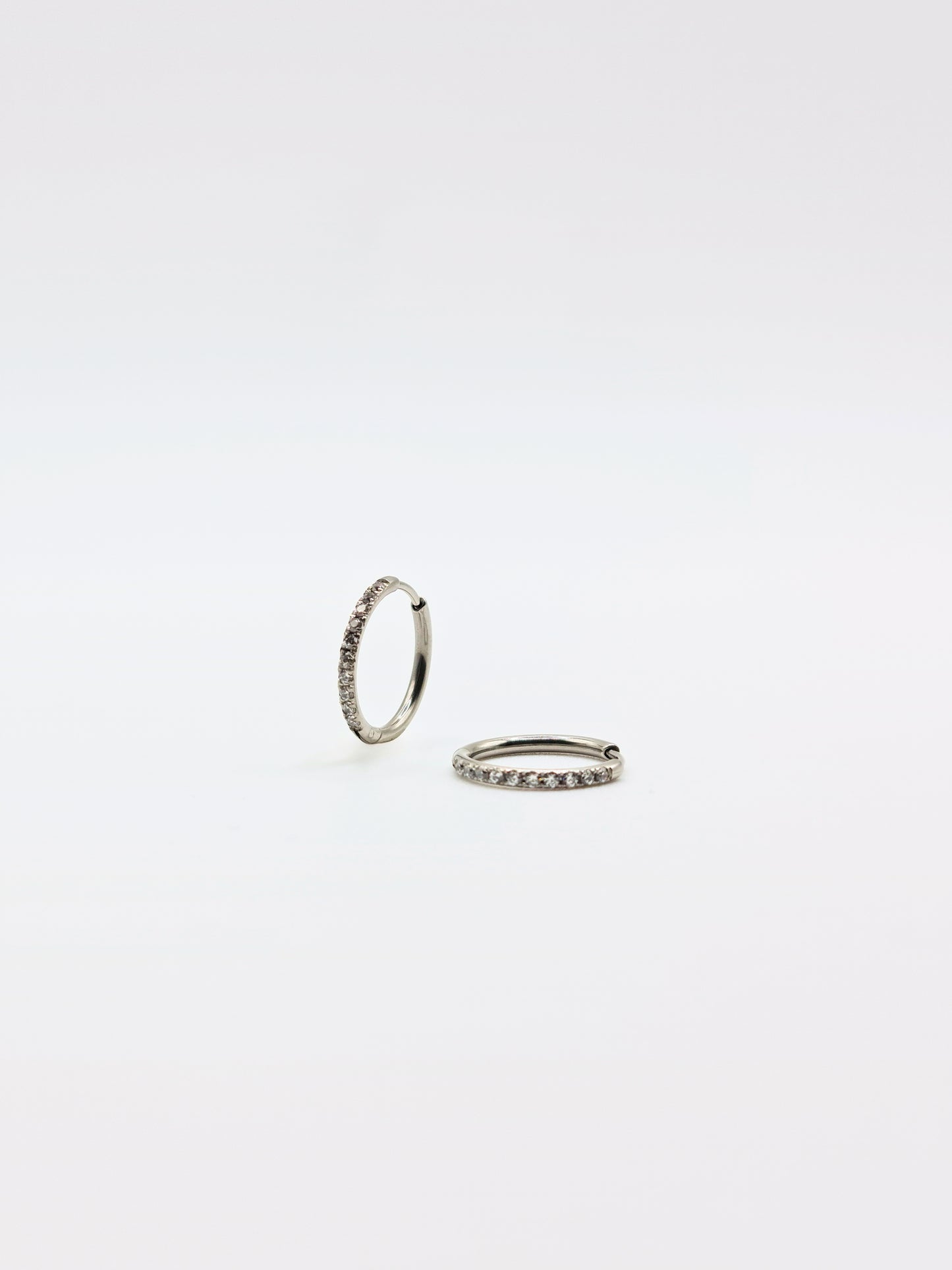 The Alaia Essentials Silver Finish Tarnish-Free Crystal Pave Huggie Hoop Earrings in 12mm