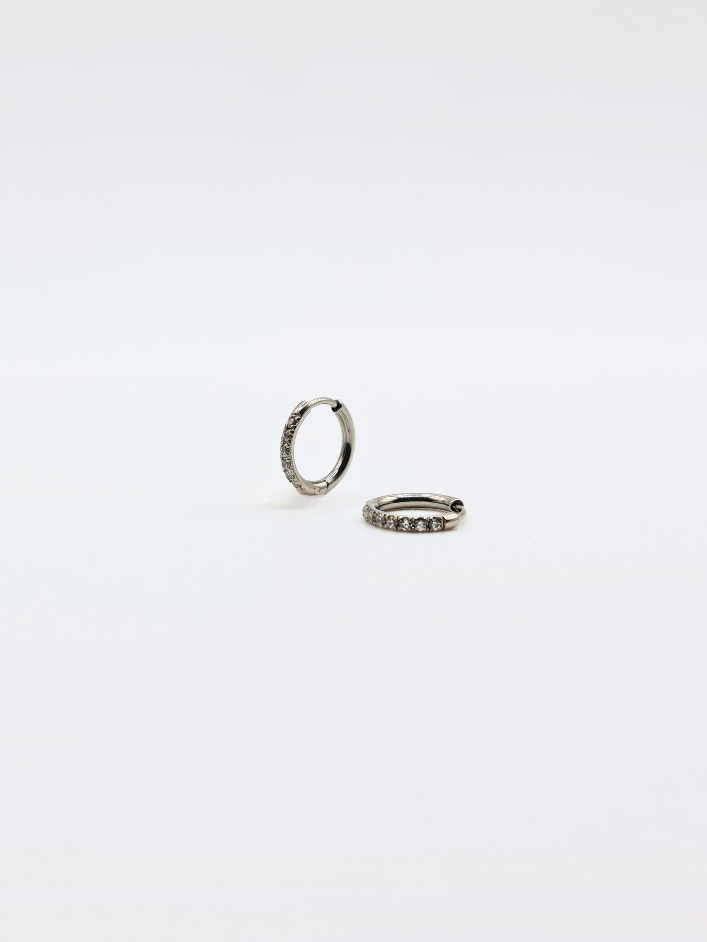 The Alaia Essentials Silver Finish Tarnish-Free Crystal Pave Huggie Hoop Earrings in 8mm
