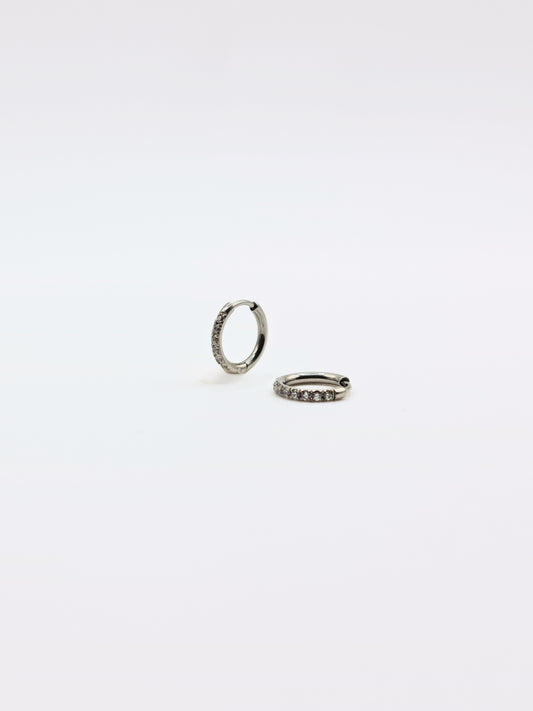 The Alaia Essentials Silver Finish Tarnish-Free Crystal Pave Huggie Hoop Earrings in 8mm