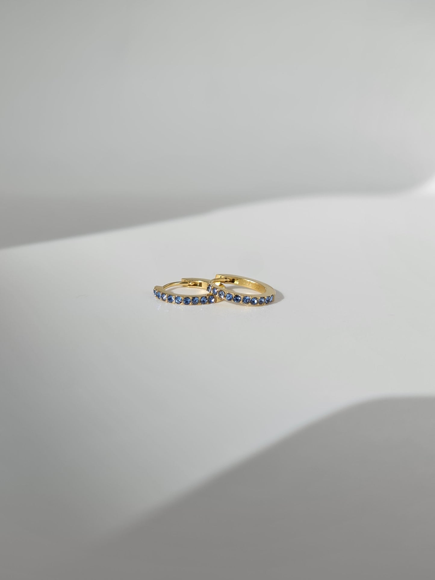 The Maija 'March' Aquamarine Birthstone 18k Gold Plated Stainless Steel Crystal Huggie Hoop Earrings.