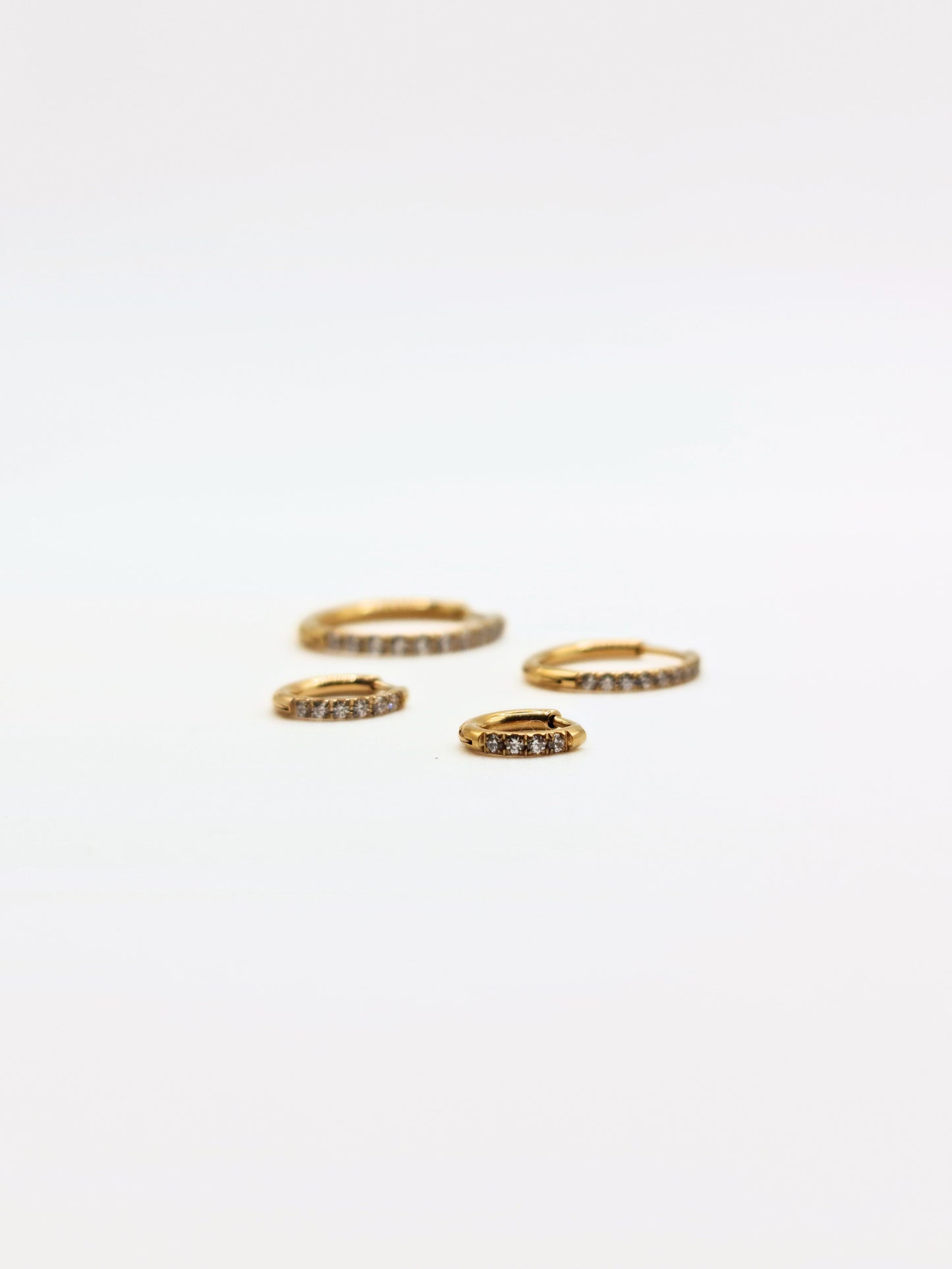 The Alaia Essentials 18k Gold Plated Tarnish-Free Crystal Pave Huggie Hoop Earrings in 8mm