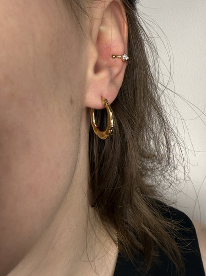 The Ashley 18k Gold Plated Stainless Steel Twist Etched Hoop Earrings.